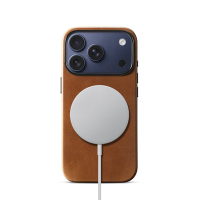 Brown leather phone case shown with a charging accessory; charger not included