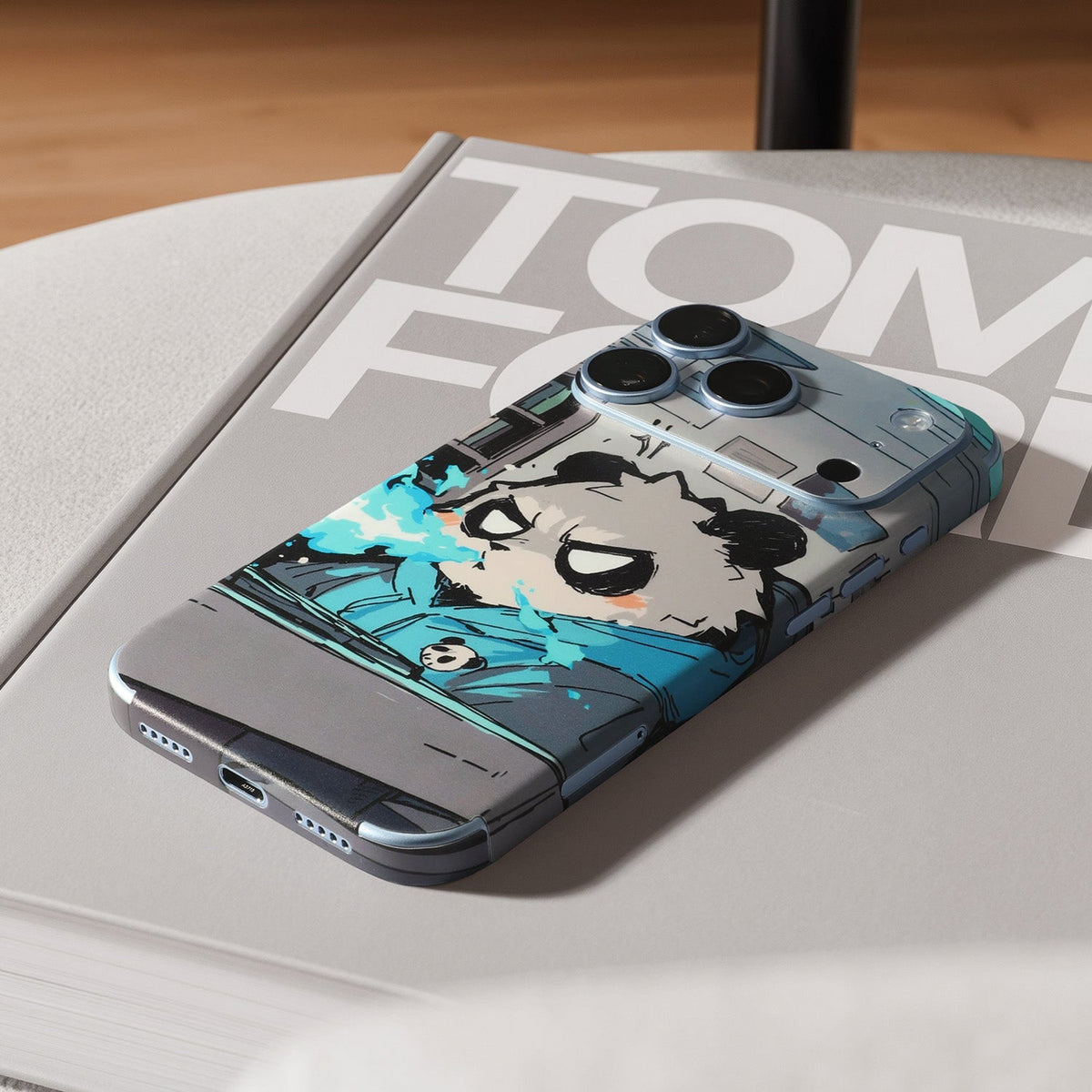 STICKSOO full-body Phone Skin, real photo on Glacier iPhone 18 Pro, tabletop lifestyle view; alternate-colour example for this product